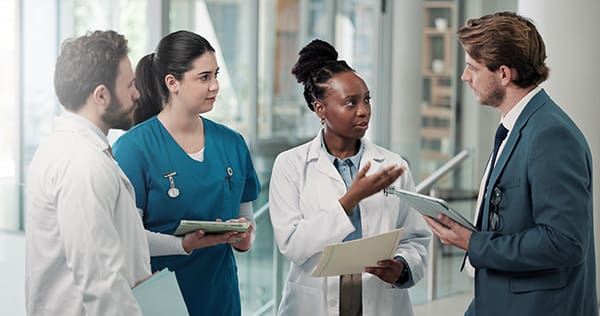 Businessman,,Doctors,Or,Meeting,With,Folder,In,Clinic,For,Medical